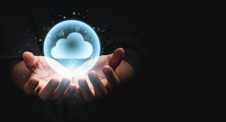 Two hands holding virtual could computing with technology icons with dark background and copy space for technology transformation and sharing concept.