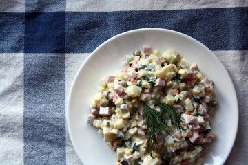 Salad of potatoes, sausage, peas, carrots and cucumbers. Olivier.