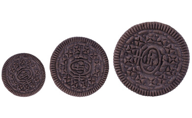 Chocolate sandwich cookies of different sizes with toppings on an isolated white background.