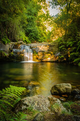 Beautiful water stream in Poço da Cilha waterfall, Manhouce, Sao Pedro do Sul, Portugal. Long exposure smooth effect. Mountain forest landscape.