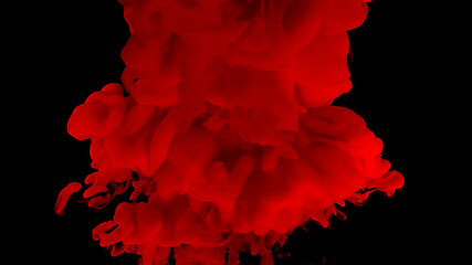 Beautiful abstract background. Red watercolor ink in water on a black background. Waves and drops...