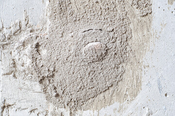 Untreated concrete block wall with roughly sealed joints and holes during construction. Improper repairs or finishing work