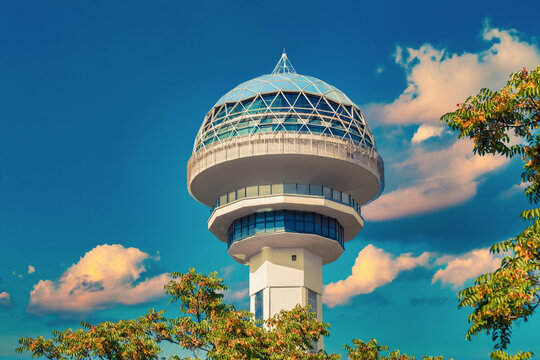 Atakule behind the branches. Symbol of Ankara in front of sky. Popular touristic landmark of the capital city with 125m height. Ufo shaped dome is an example of modern architecture.
