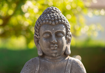 Head of a Buddha sculpture with a green background