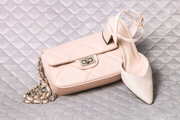 Leather beige female handbag and high-heeled shoes