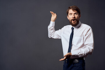 bearded man holding a tie executive office dark background
