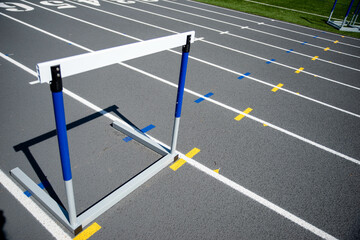 One hurdle in place on an athletic running track