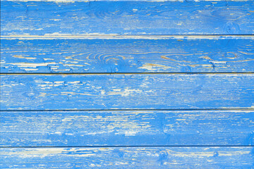 Old wooden boards with peeling blue paint