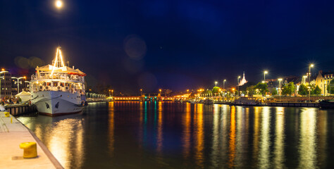 Szczecin. Night view from across the river to the illuminated historic center. Odra river. Chrobry...