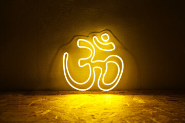 Yellow neon sign OM. Om symbol glow background. Hindu religion. Trendy style. Neon sign. Custom neon. Home decor. Relax vibe.