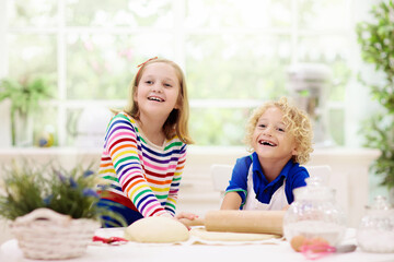 Obraz na płótnie Canvas Kids baking. Children cooking in white kitchen.