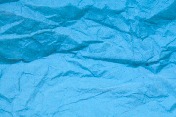 Blue crumpled paper background.