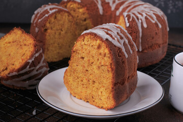 A slice of pumpkin bundt cake served with tea. 