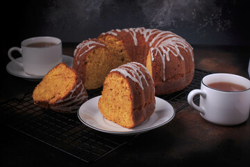 A slice of pumpkin bundt cake served with tea. 