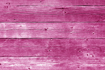 Part of wooden house wall in pink tone.