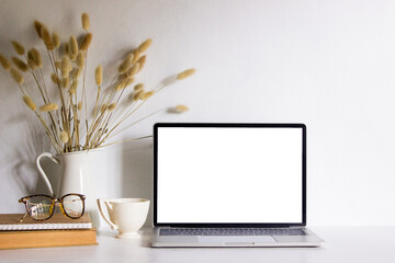 Mock up computer device with flowers and coffee over the white background. 