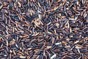Black rice berries background.