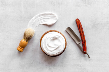 Set of shaving tools with barber razor and foam in wooden bowl