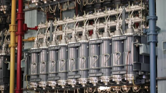 Industrial Electrochemical Facility. The Camera Moving Downwards showing A Close Up of Multiple Devices for the Separation of the uranium isotopes with a Grey Colored Base. Gas Centrifuges.