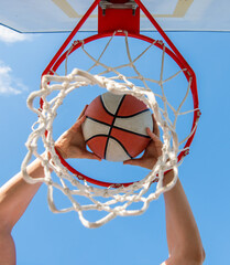 sport success. scoring while basketball game. ball goes through basket. © Olena