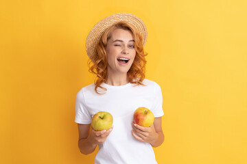 happy winking redhead woman in straw hat hold apple, lunch break