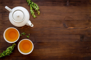 Asian food and drink background white teapot and black tea in two cups