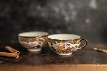 two china cups filled with tea leaves in hot water