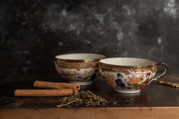 two china cups filled with tea leaves in hot water
