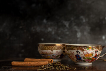two china cups filled with tea leaves in hot water