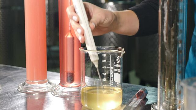 Winery, wine production. Quality control. winemakers laboratory testing wine in winery lab. Measurement alcohol content cold stability density malic acid red grape color sugar sulfur dioxide pH. 4 k