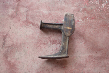 Old weathered metal tool for shoemakers