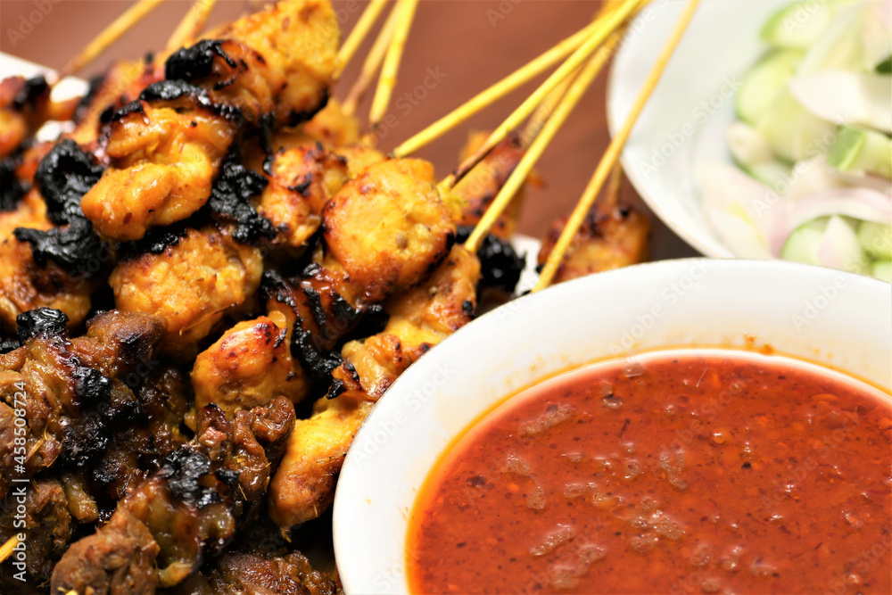 Poster Traditional Malaysian barbeque dish called sate, served with spicy peanut sauce