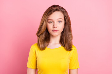 Photo of young attractive school girl serious confident wear yellow t-shirt isolated over pink...