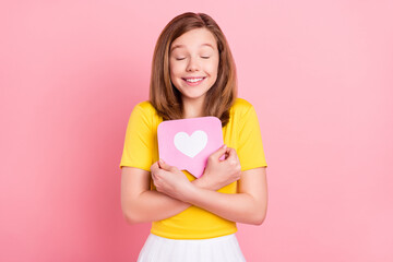 Photo of sweet blond teen girl hug like wear yellow t-shirt isolated on pink color background