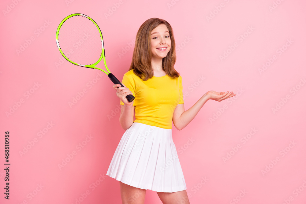 Poster photo of good blond little girl hold racket wear yellow t-shirt skirt isolated on pink color backgro