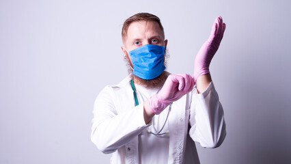 Male doctor in laboratory coat on gray background