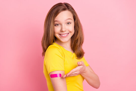 Profile side photo of young girl happy positive smile demonstrate hand plaster vaccination isolated over pink color background