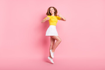 Full body profile side photo of young girl happy smile jump show thumb-up like cool fine ad isolated over pink color background
