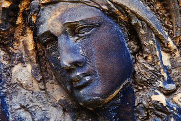 Fototapeta na wymiar Fragment of an ancient very beautiful statue of Virgin Mary