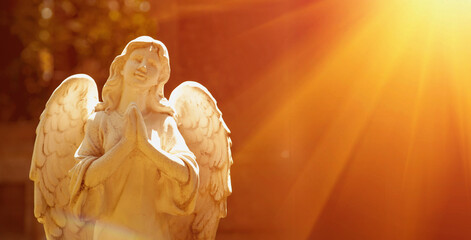 Wonderful angel in the rays of the sun (architecture, statue, archetype, religion, faith)....