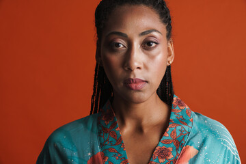 Black woman wearing kimono posing and looking at camera