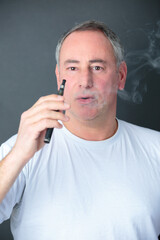 a man smokes an e cigarette