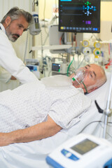 Fototapeta premium doctor does inhalation elderly man