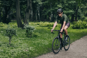 Fototapeta na wymiar Sportsman in safety helmet biking on fresh air