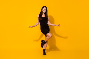 Fototapeta na wymiar Full length photo of attractive young positive charming woman good mood isolated on yellow color background