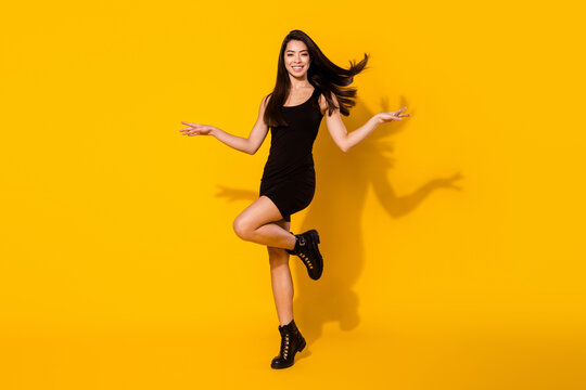 Full size photo of impressed brunette hairdo young lady dance wear black dress shoes isolated on yellow color background