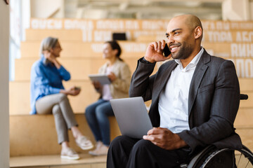 Afro american man manager in wheelchair working