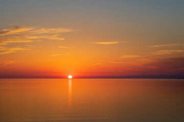Sun going down at sunset over a calm sea