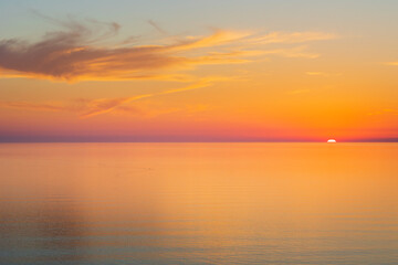 Sun going down at sunset over a calm sea
