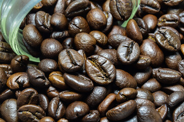 Close-up of coffee beans with details cracked by heat on a white background.